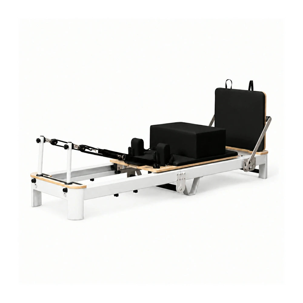 Black pilates reformer with textured grip on a white background